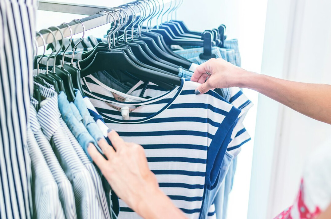 person choosing clothes in store