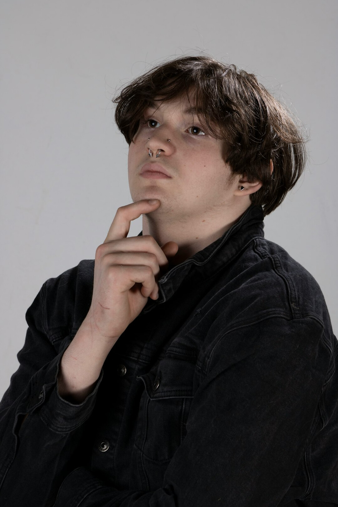 Studio portrait of a thoughtful middle-aged researcher looking away from the camera